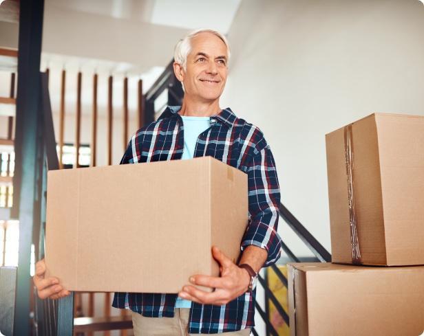 Photo of happy man with moving boxes